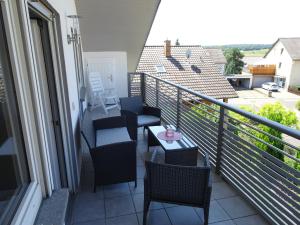 a balcony with chairs and a table on a balcony at Haus Panorama in Massenbachhausen