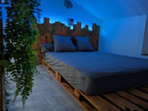 a bedroom with a bed with a wooden headboard at Cozy AM Spa and Cinema in Andance +16 photos