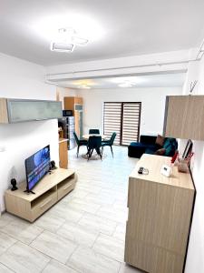 a living room with a couch and a tv in it at CRISTAL Apartament Căpșunilor nr 2 in Craiova