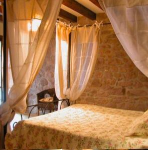 a bedroom with a bed with curtains at Casa rural Ballenea in Errazu