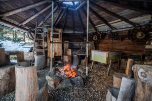 a stove in a cabin with a fire at Chata U Valentů in Červená Voda