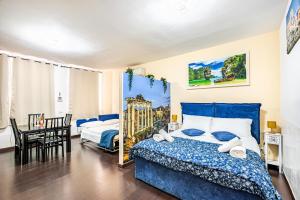 a bedroom with a blue bed and a table at Deluxe Apartments Pantheon in Rome