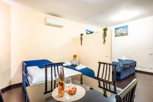 a room with two beds and a table with drinks on it at Deluxe Apartments Pantheon in Rome