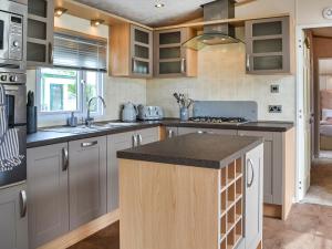 a kitchen with gray cabinets and a counter top at Lavender Lodge in Patrington