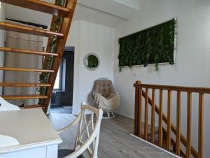 a living room with a staircase and a painting on the wall at Cozy AM Spa and Cinema in Andance