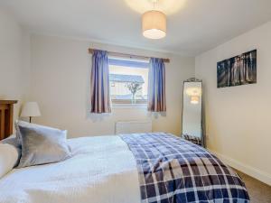 a bedroom with a bed and a window at The Barn in Kilmory +9 photos
