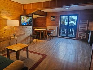 a room with tables and chairs in a room with wooden walls at boutique appartementsKOFLER in Mallnitz