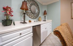 a bathroom with a white counter and a mirror at Phoenix on the Bay 1324 in Orange Beach