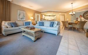 a living room with a couch and a table at Phoenix on the Bay 1324 in Orange Beach