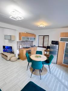 a kitchen with a table and chairs in a room at CRISTAL Apartament Căpșunilor nr 2 in Craiova