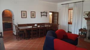 a living room with a dining room table and chairs at Casabei in Monticiano +21 photos