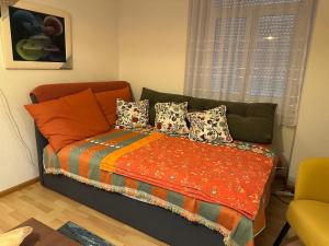 a bed with pillows on it in a room at Goetheanum Casa in Dornach