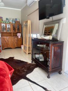 a living room with a tv and a mirror at Magalies B&B SPITSKOP in Bloemfontein +38 photos
