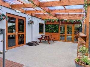 a patio with a wooden pergola and a picnic bench at 147 Snowdon Drive, Glan Gwna Holiday Park in Caernarfon