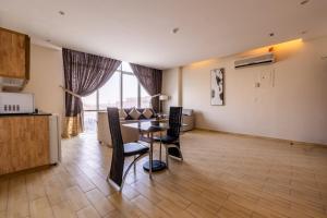 a dining room with a table and chairs in a room at Al Muhaidb Residence Al Malaz 4 - Economic in Riyadh +16 photos