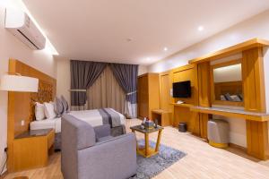a hotel room with a bed and a chair at Al Muhaidb Residence Al Malaz 4 - Economic in Riyadh