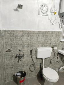 a bathroom with a toilet and a shower at Peter and Paul Homestay in Shillong