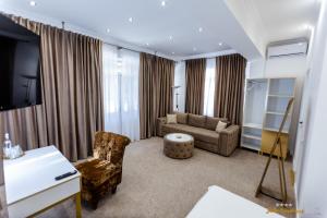 a living room with a couch and a chair at Villa Jolie in Craiova