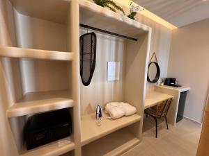 a room with a closet with a television and a desk at EvMariA suites in Fira +66 photos