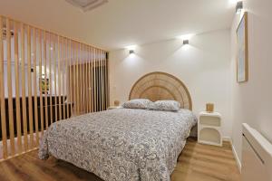 a bedroom with a large bed and a staircase at Le Ciné Lodge Provence in Flassans-sur-Issole