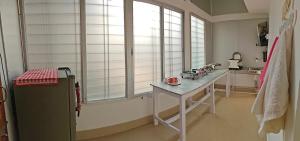 a kitchen with a counter and a table in a room at La Paloma in Dispur