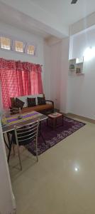 a living room with a couch and a table at La Paloma in Dispur