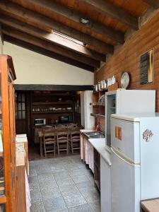 a kitchen with a white refrigerator and a counter at Fundalucia Guesthouse in Quéntar