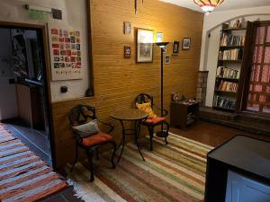 a room with two chairs and a table in a library at Fundalucia Guesthouse in Quéntar