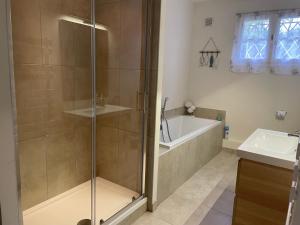 a bathroom with a shower and a tub and a sink at Maison Mariela in Luzech +33 photos