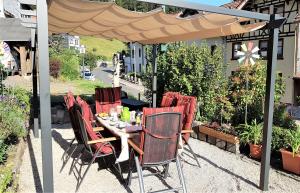 a table and chairs under an umbrella on a patio at Ferienwohnung Zur Rennsteigruh in Ruhla