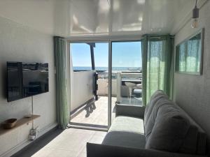 a living room with a couch and a view of the ocean at Sunset in Cap d'Agde