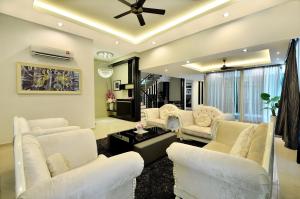 a living room with white furniture and a ceiling fan at Iris Luxury Service Villa in George Town