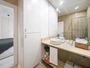 a bathroom with a sink and a mirror at Beach House Old Town in Cascais +26 photos