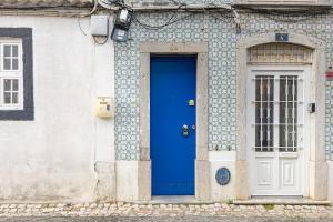 a blue door on the side of a building at Beach House Old Town in Cascais