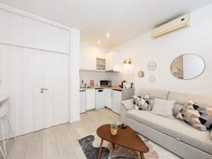 a living room with a couch and a table at Beach House Old Town in Cascais