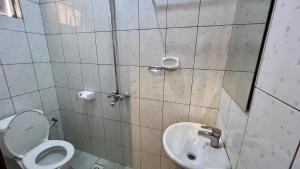 a bathroom with a toilet and a sink at Dolphin AIR B&B in Arusha +5 photos