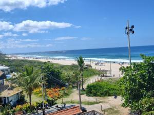 a view of a beach and the ocean at Surf Zone Hostel in Saquarema