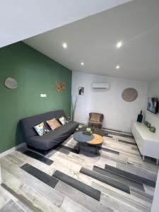 a living room with a couch and a table at Lodge La Forêt in Les Sables-d'Olonne