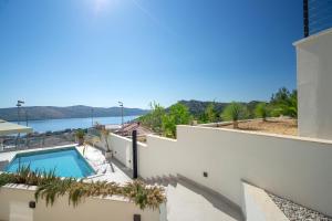 a view of a house with a swimming pool at Villa Luca in Seget Vranjica