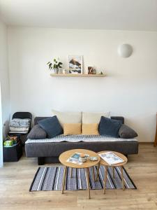 a living room with a couch and a table at Apartmán Karo, oddych v centre Oščadnice in Oščadnica