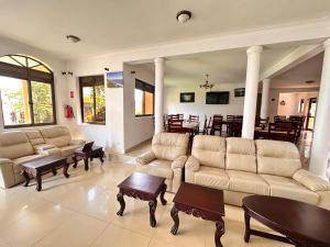 a large living room with couches and a dining room at Sienna Beach Hotel - Entebbe in Entebbe