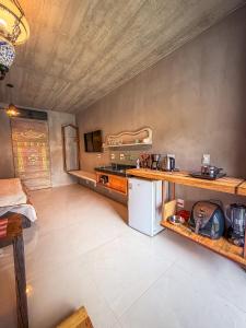 a kitchen with a counter and a refrigerator in a room at Vila Carmen Imperial in Domingos Martins
