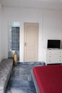 a bedroom with a bed and a white door at Canelle appart tout équipé et lumineux in Dzaoudzi