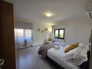 a bedroom with a large bed and a window at Zenzero Comfort Apartment in Bellagio