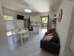 a living room and kitchen with a couch and a table at Zenzero Comfort Apartment in Bellagio