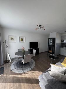 a living room with a table and a couch at Kal's Studio Apartment Salzburg in Salzburg