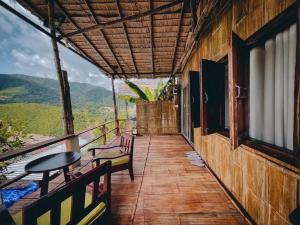 a balcony of a house with a table and chairs at Sapan Goodview สะปันกู๊ดวิว in Ban Na Luang +14 photos