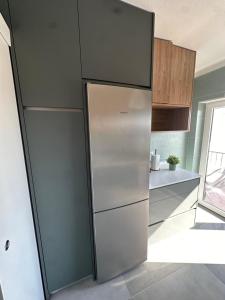 a stainless steel refrigerator in a kitchen at JP House in Figueira da Foz