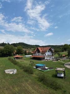 a house in a field with a picnic table at Rtanjska bajka in Boljevac