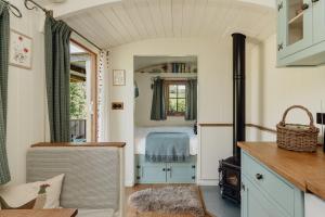 a small room with a bed and a window at Hurdlemakers Hut in Dorchester